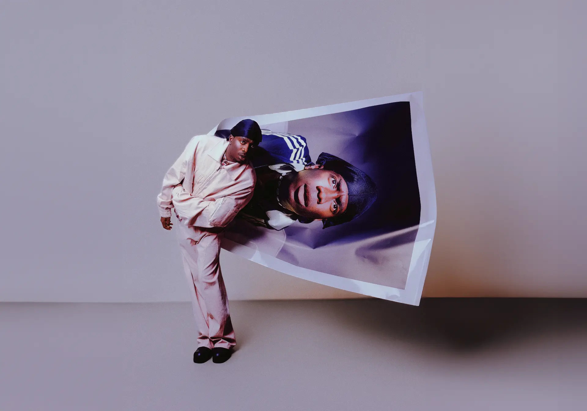 MasterPeace beside a folded photographic portrait
