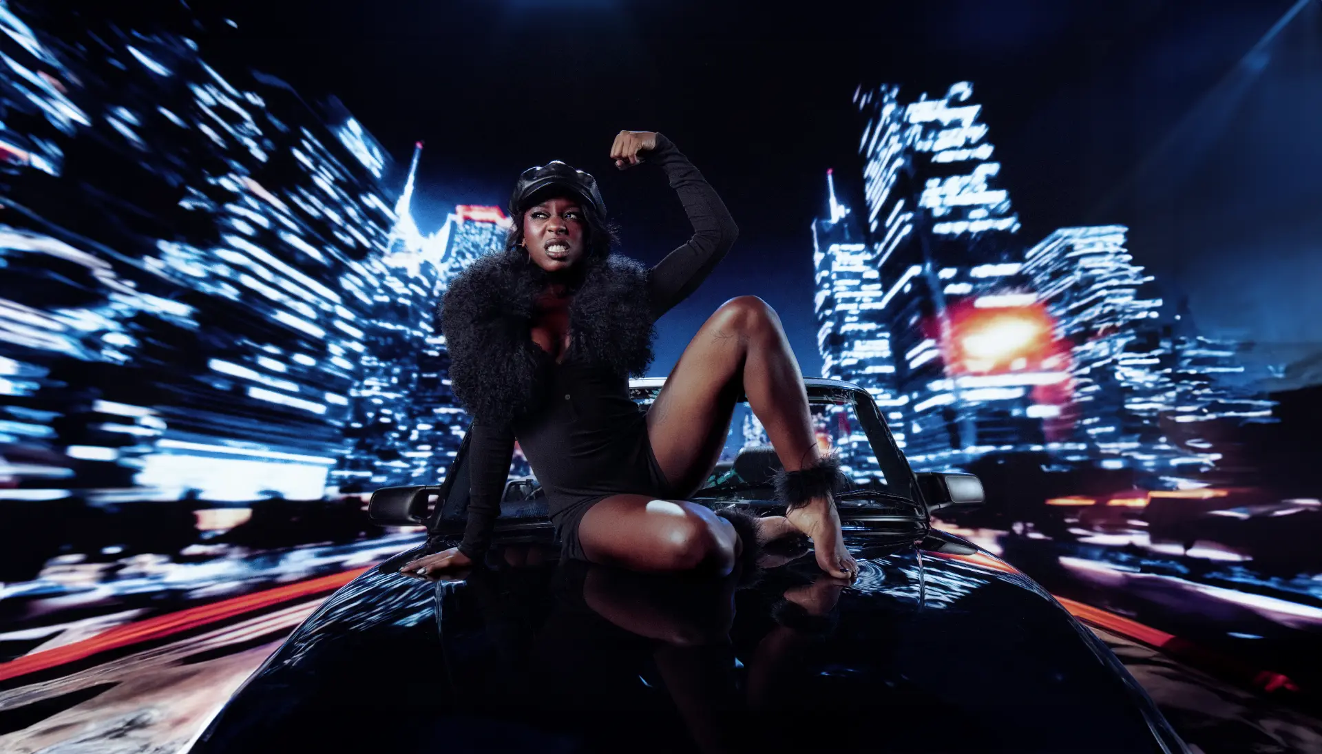 Catching Cairo — performer crouched on a car bonnet against a blurred night skyline