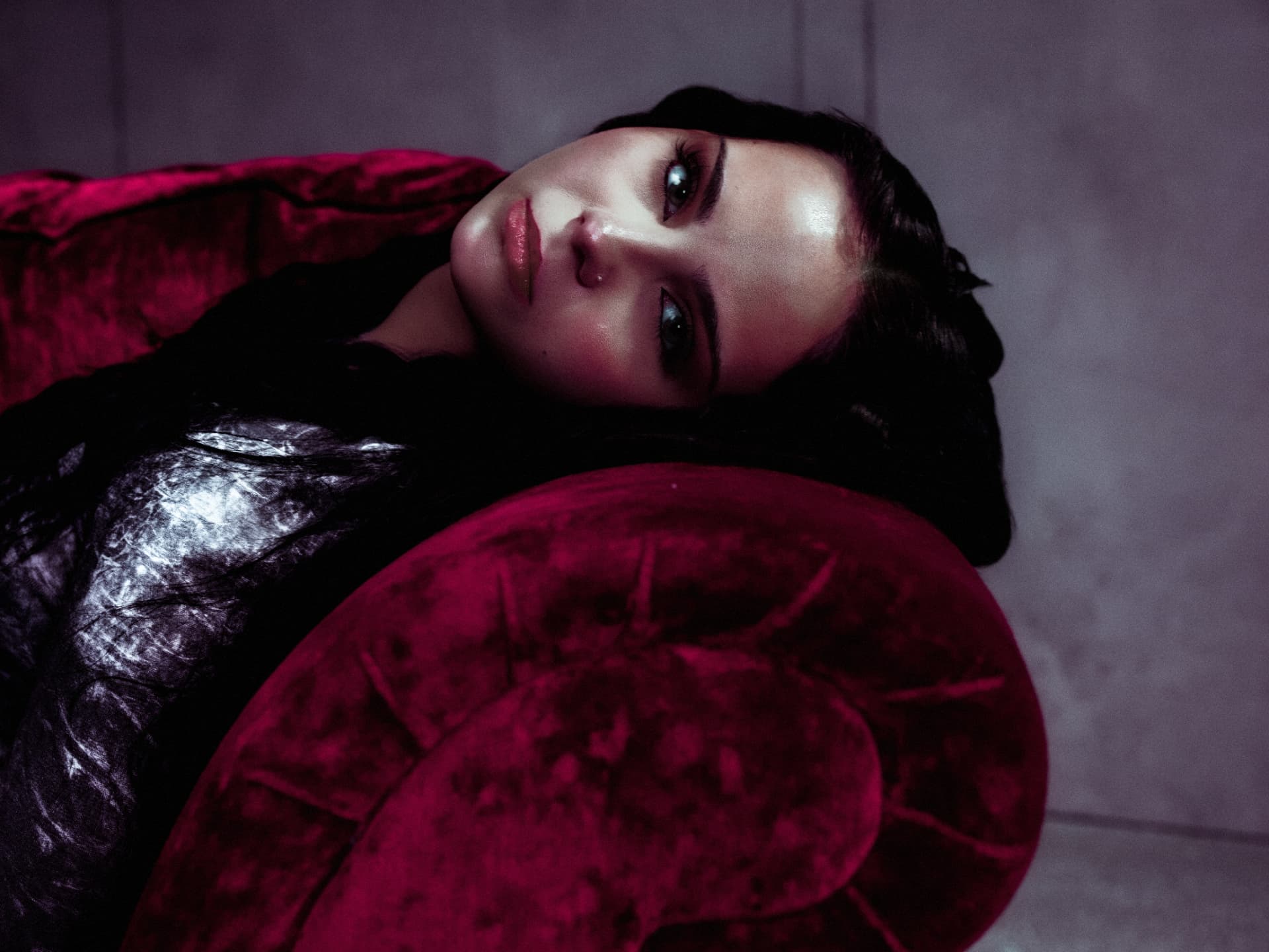 Close portrait of Sabyna on a crimson sofa